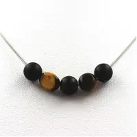 Bijoux Pierres et Minéraux. Collier perles Onyx noir mat 8 mm + Oeil de Tigre d'Afrique du Sud Chaine en acier inoxydable.